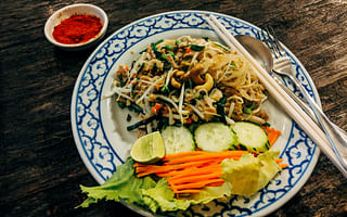 What are some must-try Thai dishes while visiting Thailand?